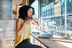 Window, laptop and internet cafe with a black woman blogger smelling a beverage during remote work. Coffee shop, freelance and startup with an attractive young female working in a restaurant