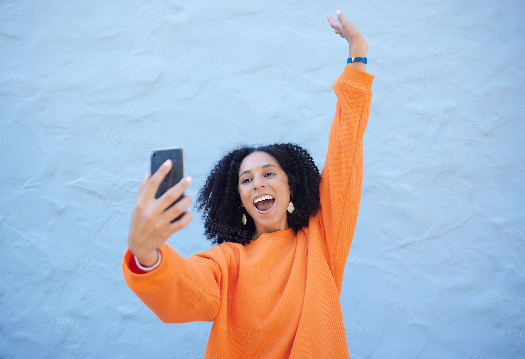 Buy stock photo Black woman excited in selfie, smartphone and success with cheers and happiness on blue background. Influencer with social media, content creation with live streaming mockup and online achievement