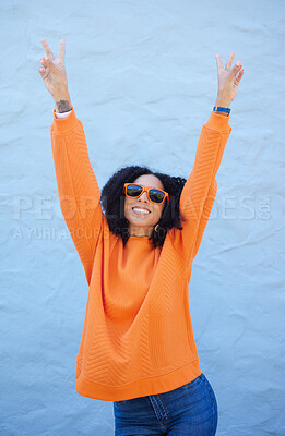 Buy stock photo Carefree, peace sign and trendy woman on a wall in the city for cool energy, playful and happy with sunglasses. Comic, fun and crazy stylish girl with a hand emoji for freedom and funky smile