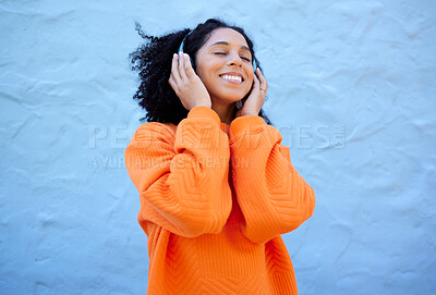 Buy stock photo Happiness, black woman and headphones for streaming, music and cheerful on blue studio background. African American female, lady or headset for audio, sounds and podcast with girl, smile and backdrop