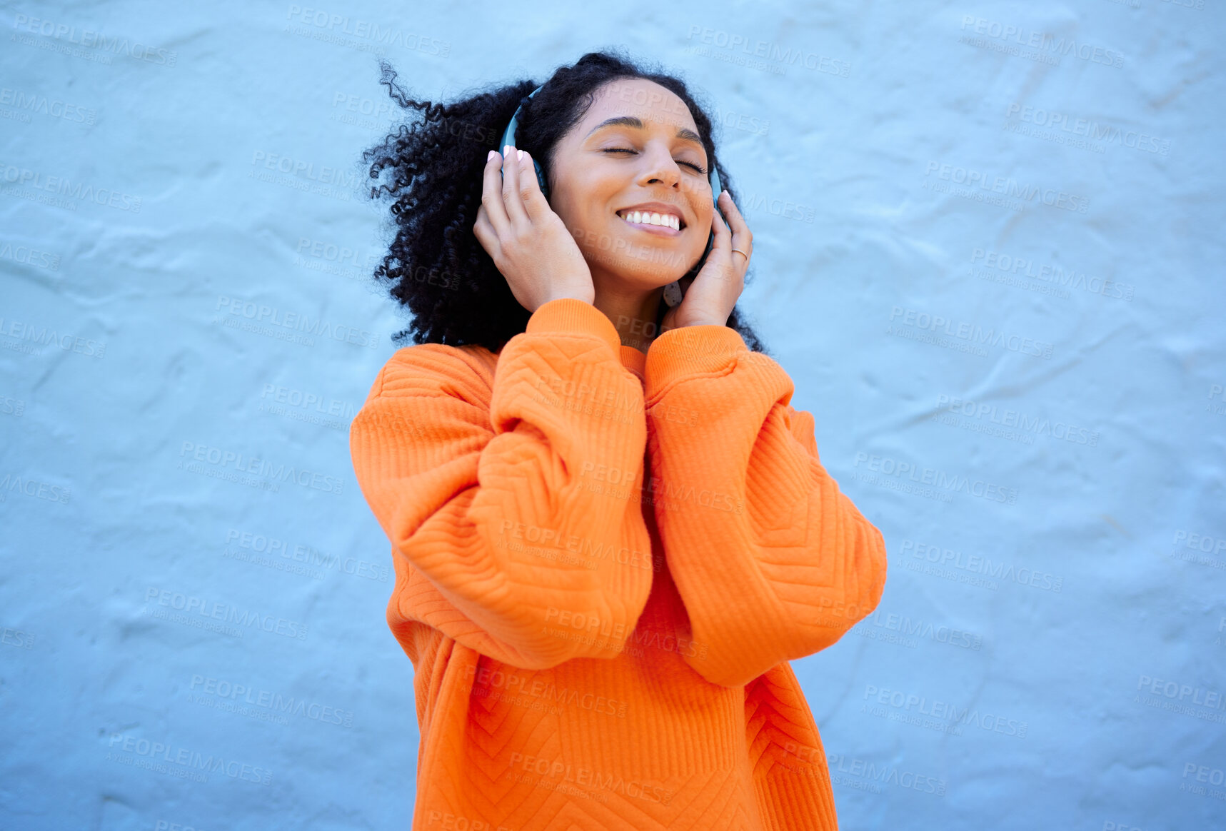 Buy stock photo Happiness, black woman and headphones for streaming, music and cheerful on blue studio background. African American female, lady or headset for audio, sounds and podcast with girl, smile and backdrop