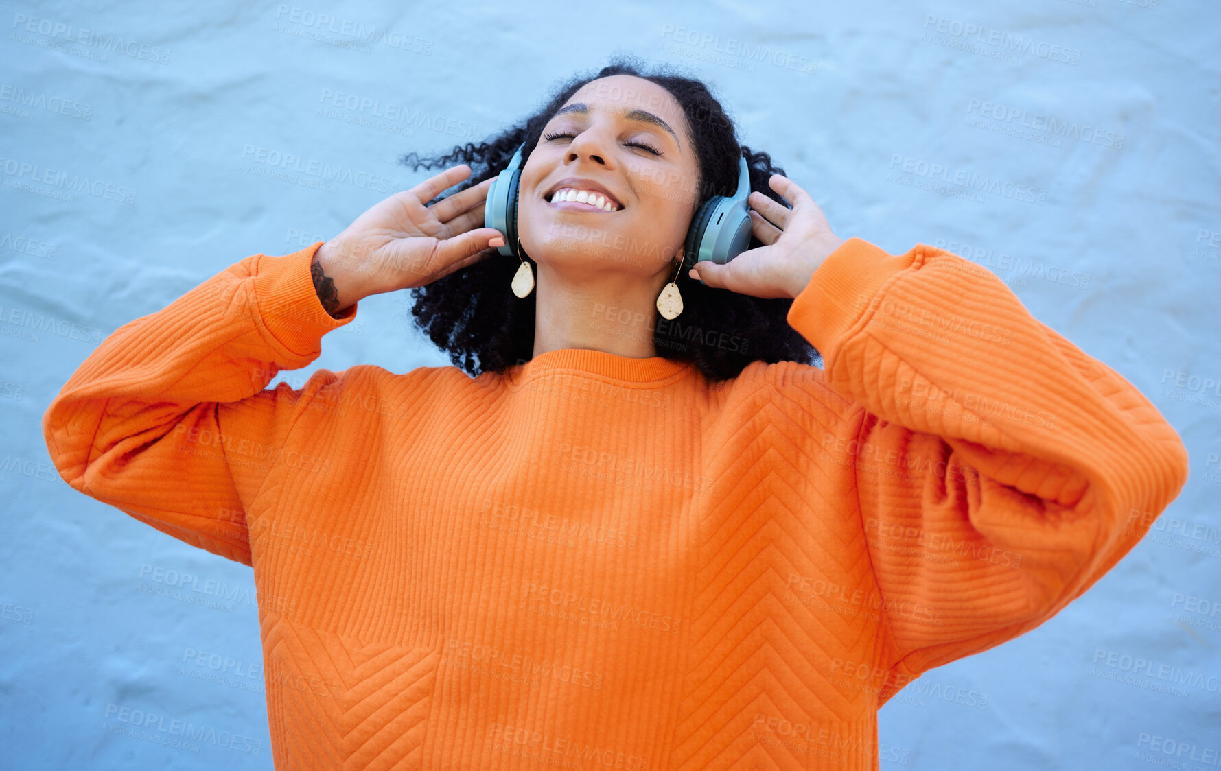 Buy stock photo Black woman, headphones and listen to music, freedom to relax with wellness and audio streaming. Happiness, care free with radio or podcast, mindset and peace of mind with playlist on blue background