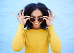 Trendy sunglasses, portrait and black woman isolated on blue background gen z, youth and fashion clothes. Ok hands of person or beauty model smile with vision style, yellow color on brick wall mockup