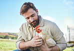Farming, food and man with a chicken on a farm for business, ecology and working in agriculture. Sustainability, environment and farmer holding a bird for a check in the countryside of Brazil