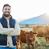 Sustainability, confidence and portrait of farmer with cows on field ...