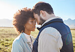 Intimacy, love and couple in nature on a farm for a romantic anniversary or valentines day date. Intimate, affection and interracial man and woman in a romance moment together on a eco friendly field