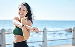 Portrait, stretching and fitness by woman at beach for running, exercise and cardio on blue sky background. Face, stretch and workout run by girl at ocean training, happy or relax, warm up or routine