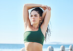 Exercise, arm stretching and fitness by woman at beach for run, sports and cardio on blue sky background. Mindset, stretch and workout by girl at ocean for training, calm or relax, warm up or routine