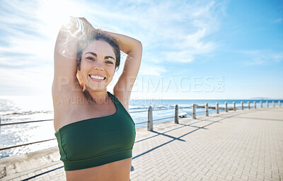 Buy stock photo Portrait, stretching and happy fitness by woman at beach for running, exercise or cardio on blue sky background. Face, stretch or workout by girl at ocean training, smile or relax, warm up or routine