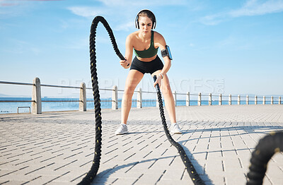 Buy stock photo Fitness, woman and battle rope at the beach for intense arm workout, training or endurance exercise. Active female with ropes in power workout, exercising or focus for muscle bodybuilding outdoors