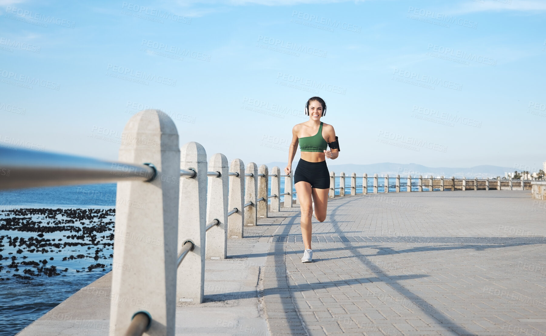 Buy stock photo Fitness, woman and running by the beach side in Cape Town for cardio exercise, training or workout. Active female runner enjoying summer run or exercising for healthy wellness in the nature outdoors
