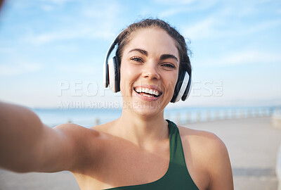 Buy stock photo Selfie, fitness and woman headphones for outdoor training, running or exercise on video call for influencer update. Music, portrait and profile picture of sports person at beach workout or cardio