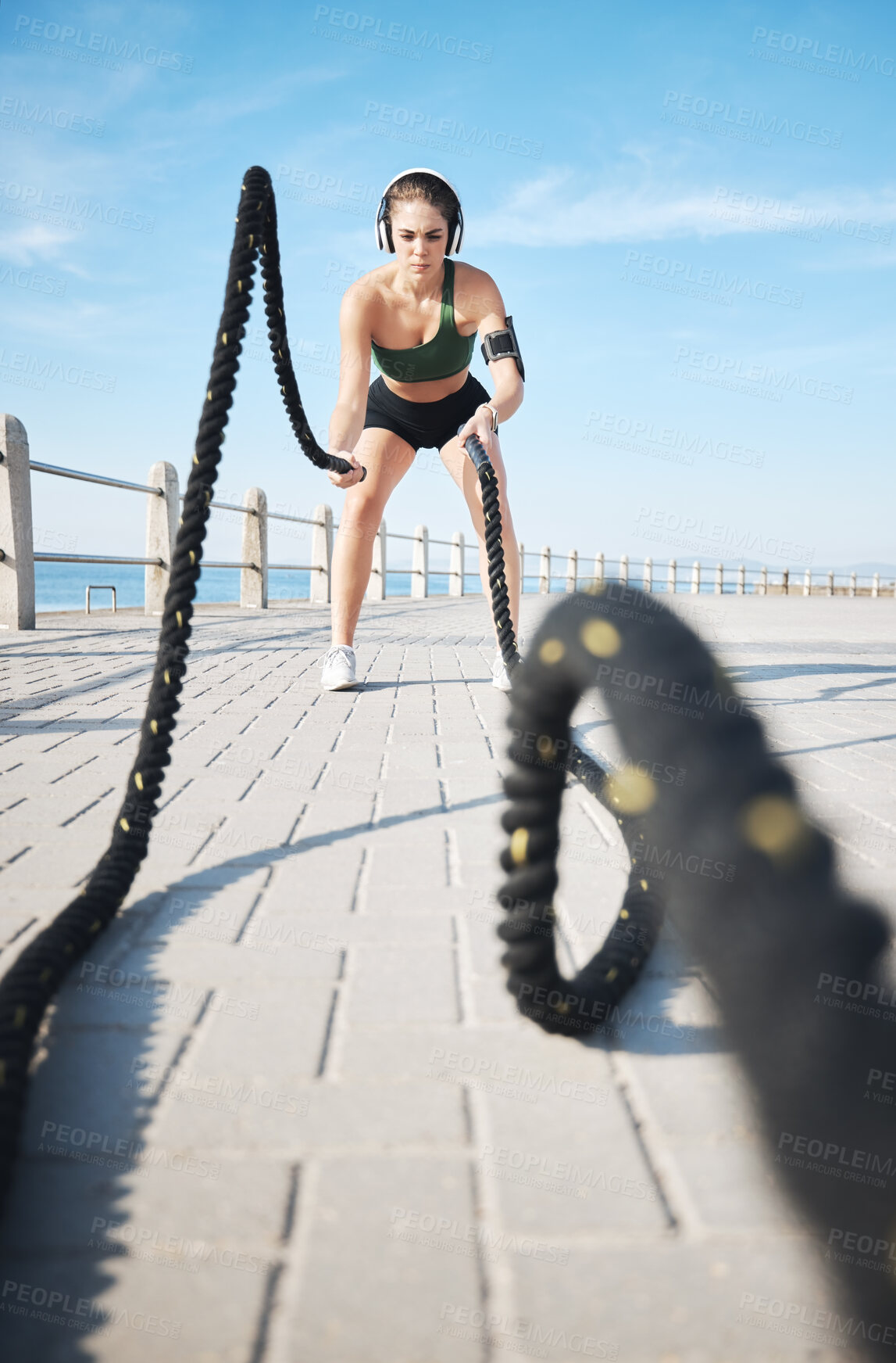 Buy stock photo Fitness, woman and battle rope for intense arm workout, training or endurance exercise at the beach. Active female with ropes in power intensity exercising or focus for muscle bodybuilding outdoors