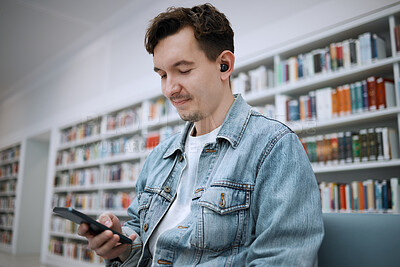 Buy stock photo Phone, library and student listening to music for education podcast, mental health and relax at university for learning. Person or man on smartphone, audio technology for campus or college study info