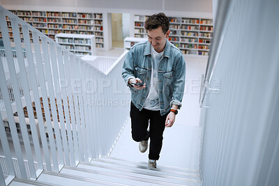 Buy stock photo Staircase, university or man with phone in library for research, communication or blog news. Book, education or happy student on smartphone for scholarship networking, social media or online content