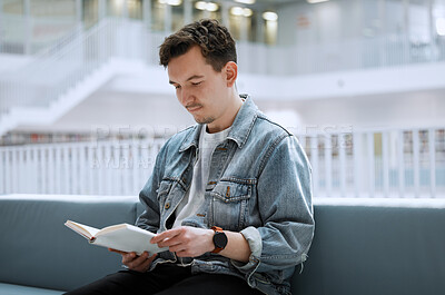 Buy stock photo Education, library and man with a book, reading and studying for a test, exam and knowledge. Male, student and academic with journal, research or focus on learning, peace and relax with calm or quiet