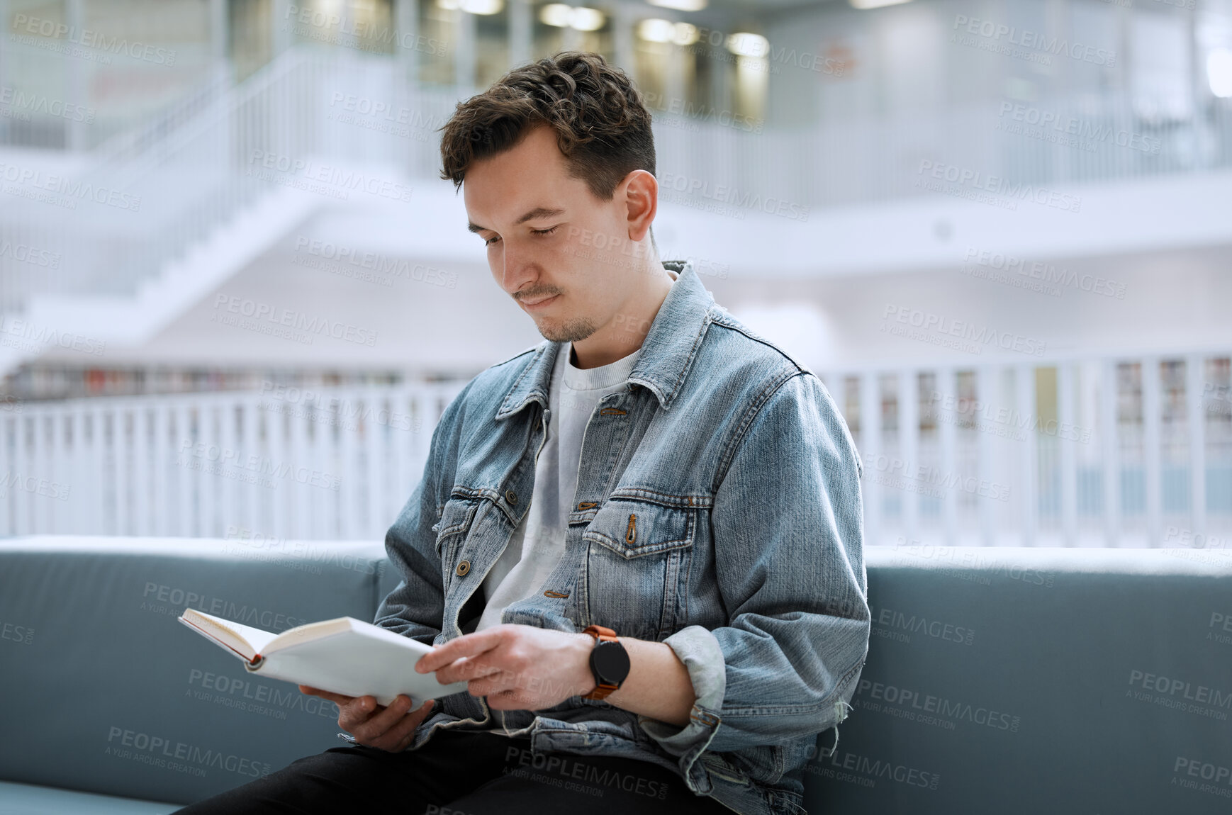 Buy stock photo Education, library and man with a book, reading and studying for a test, exam and knowledge. Male, student and academic with journal, research or focus on learning, peace and relax with calm or quiet