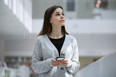 Buy stock photo Social media, education or woman with phone in library for research, communication or blog news. Thinking, university or student on smartphone for scholarship networking, website or online content