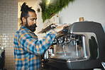 Man in cafe, barista working machine and create drink with focus and small business, workflow and process. Espresso, latte or cappuccino production, busy server in coffee shop with steam for cleaning