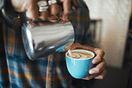 Latte art, coffee and barista hands with process, workflow and production with drink and working in cafe. Creative, man drawing with milk foam and hospitality with service and beverage closeup