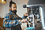 Man in coffee shop, barista working machine and create drink with focus and small business, workflow and process. Espresso, latte or cappuccino production zoom, busy server in cafe and professional