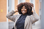 Black woman, portrait smile and afro for fashion, style or hair in city travel, trip or journey. Happy African American female touching stylish curls and smiling in happiness for traveling in town