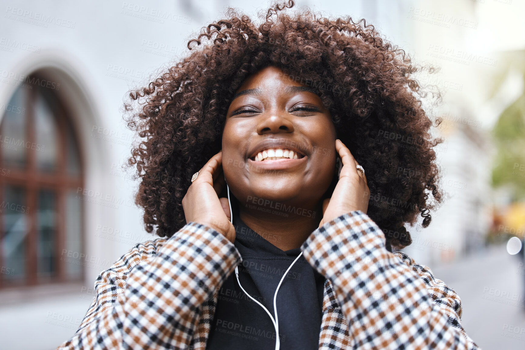 Buy stock photo Freedom, city and black woman listening to music, radio or song in the street while walking to work. Happy, smile and African female streaming playlist, album or audio with earphones in road in town.