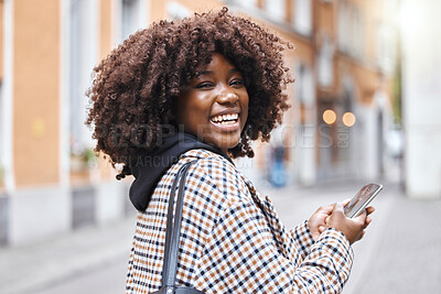 Buy stock photo Phone, happy and portrait of a black woman in the city networking on social media, mobile app or internet. Happiness, smile and African female typing a message on a cellphone while walking in town.