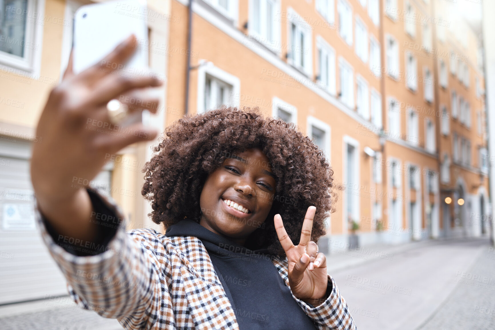 Buy stock photo Selfie, peace hand sign and black woman in a city on travel with a phone and happiness outdoor. Urban street, vacation and smile of a young person on social media for holiday traveling feeling relax