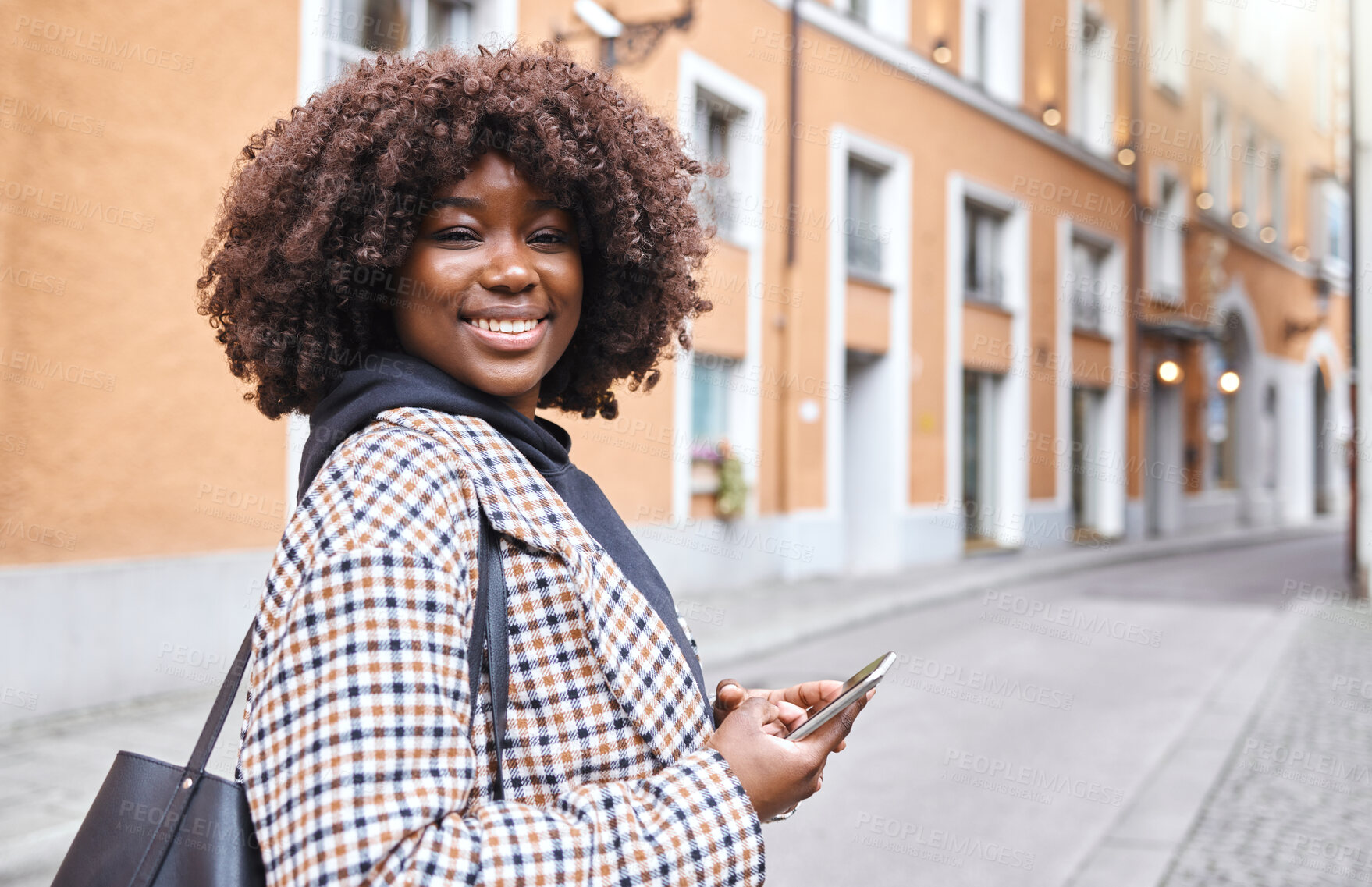 Buy stock photo Portrait, phone and mockup with a black woman in the city for travel, tourism or adventure overseas. Smile, mobile and mock up with a female traveler outside in a foreign town in Germany 