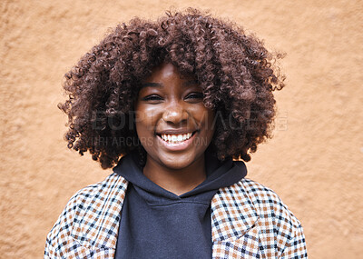 Buy stock photo Black woman, portrait and afro on wall background in city, urban town or fun in Kenya. Happy young african female smile for happiness, face and curly hair outdoors with fashion, motivation or freedom