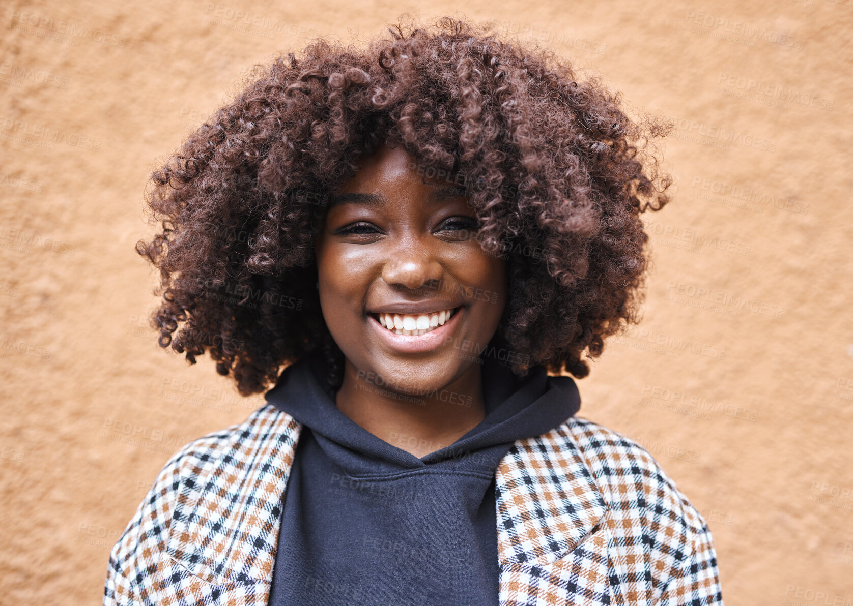 Buy stock photo Black woman, portrait and afro on wall background in city, urban town or fun in Kenya. Happy young african female smile for happiness, face and curly hair outdoors with fashion, motivation or freedom