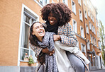 Girl friends, laughing and city travel adventure of young people with a piggyback and happiness. Freedom, diversity and women smile outdoor feeling happy on a walk on a urban holiday together