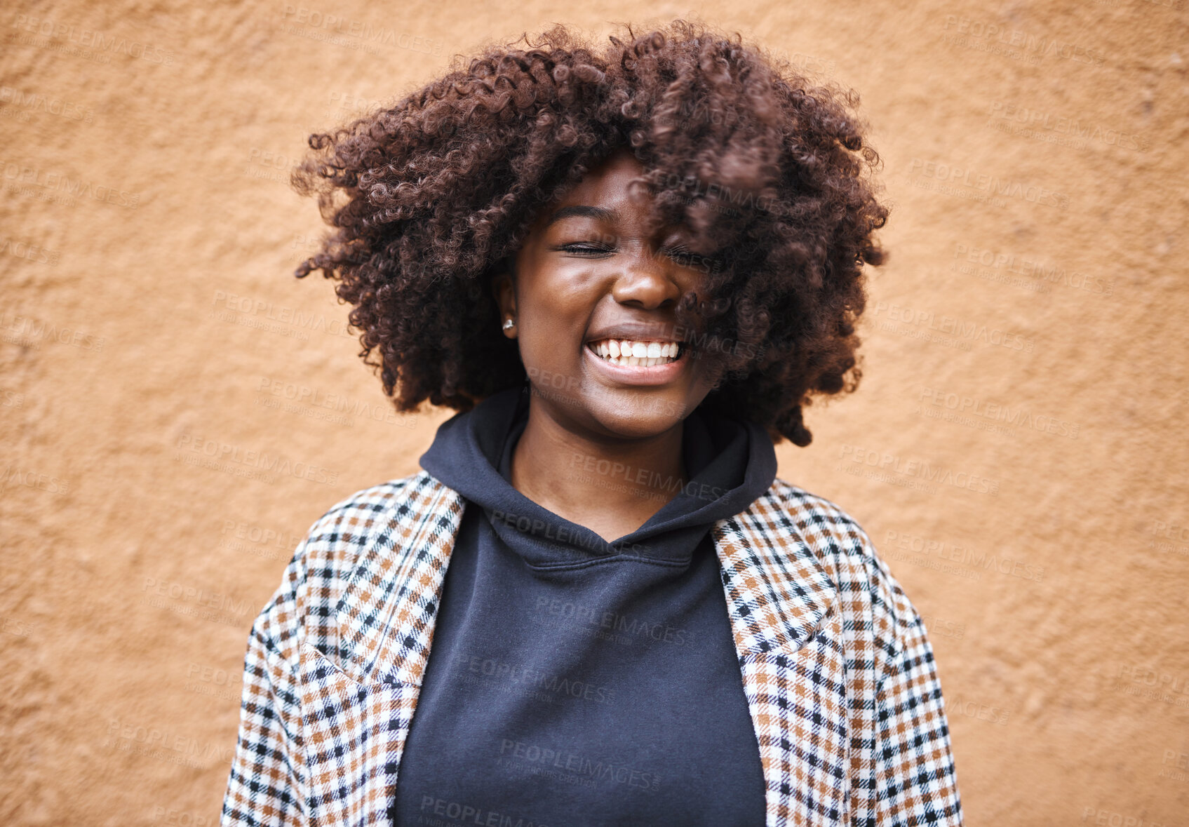 Buy stock photo Black woman, smile and happy young person by an orange wall feeling freedom and joy. Happiness, urban fashion and cool laughing African female smiling with afro hair and stylish clothing outdoor