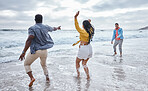 Dance, water or crazy friends at a beach to relax on holiday vacation bonding in nature together in Bali. Funny, excited men and happy women group dancing at sea enjoy traveling on ocean trips 