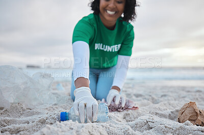 Buy stock photo Hand, bottle and a volunteer woman on the beach for community, charity or activism during a clean up. Cleaning, environment and plastic with a female picking up plastic litter or polution on a coast