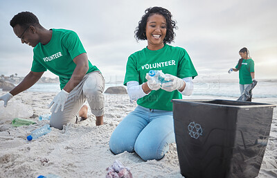 Buy stock photo Volunteer group, beach clean and recycling plastic bottle for community service, pollution and earth day. Black woman and man ngo team cleaning sand for climate change, nature and helping environment