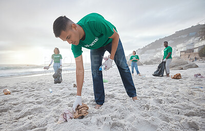 Buy stock photo Teamwork, cleaning and recycling with man on beach for sustainability, environment and eco friendly. Climate change, earth day and nature with volunteer for community service, pollution and plastic