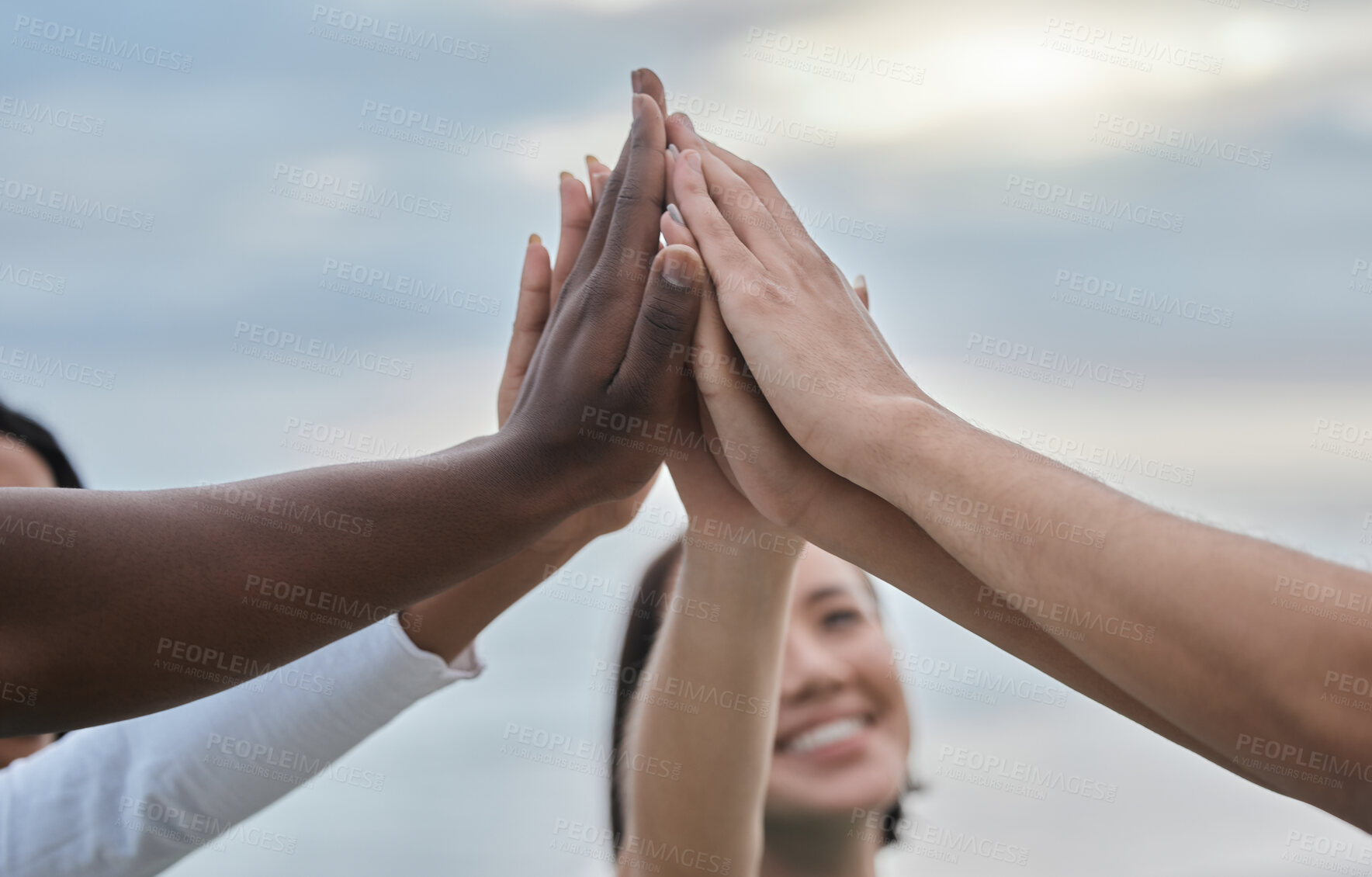 Buy stock photo High five, teamwork and unity with a group of people outdoor standing in a huddle for support or motivation. Hands, trust and partnership with a team together in a circle for collaboration from below