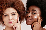 Skincare, face cream and portrait of women in a studio for a wellness, health and natural routine. Beauty, cosmetic and interracial females with facial moisturizer, spf or lotion by nude background.