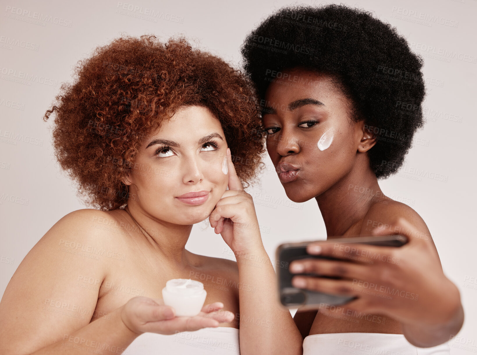 Buy stock photo Skincare, funny and facial with friends and selfie for product, beauty and spa. Comic, phone and social media with black women and silly face photo with cream for health, makeup or wellness in studio