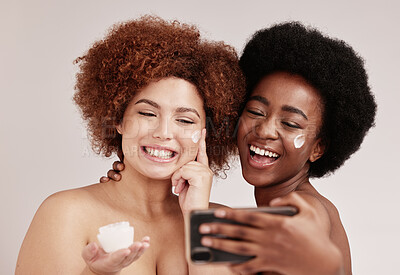 Buy stock photo Skincare, smile and beauty with friends and selfie for product, facial and spa. Cosmetic, phone and social media with cream on face of black women for health, makeup or wellness in studio background