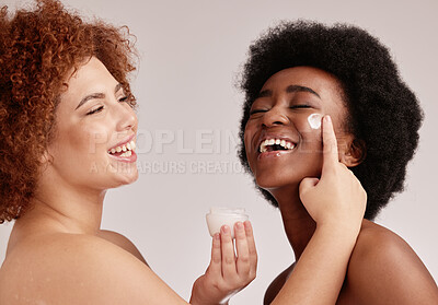 Buy stock photo Cream application, face and friends laughing with diversity and happiness for sleepover skincare. Wellness, women and spa aesthetic with lotion and moisturizer for facial and cosmetic treatment