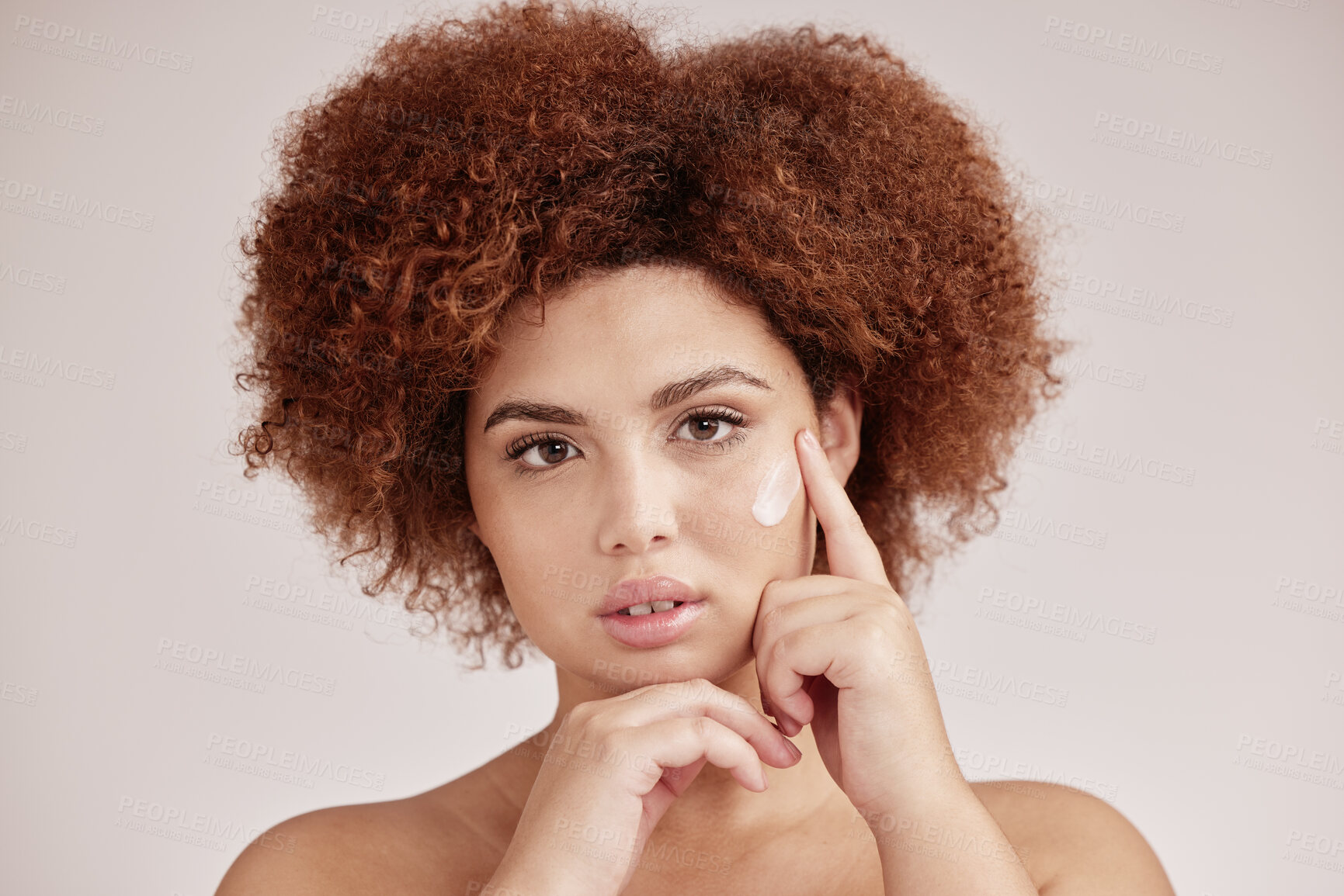 Buy stock photo Skincare, portrait of black woman with cream on serious face, afro and advertising luxury product promotion. Dermatology, cosmetics application and facial beauty, model isolated on studio background.