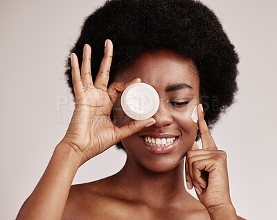 Buy stock photo Skincare, product and black woman with cream on face, afro and excited advertising luxury skin care promotion. Dermatology, spa cosmetics and facial for happy model girl isolated on studio background