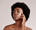 Beauty, portrait of black woman with cream on face and afro, advertising luxury skincare with collagen product promotion. Dermatology, cosmetics and spa facial for model isolated on studio background