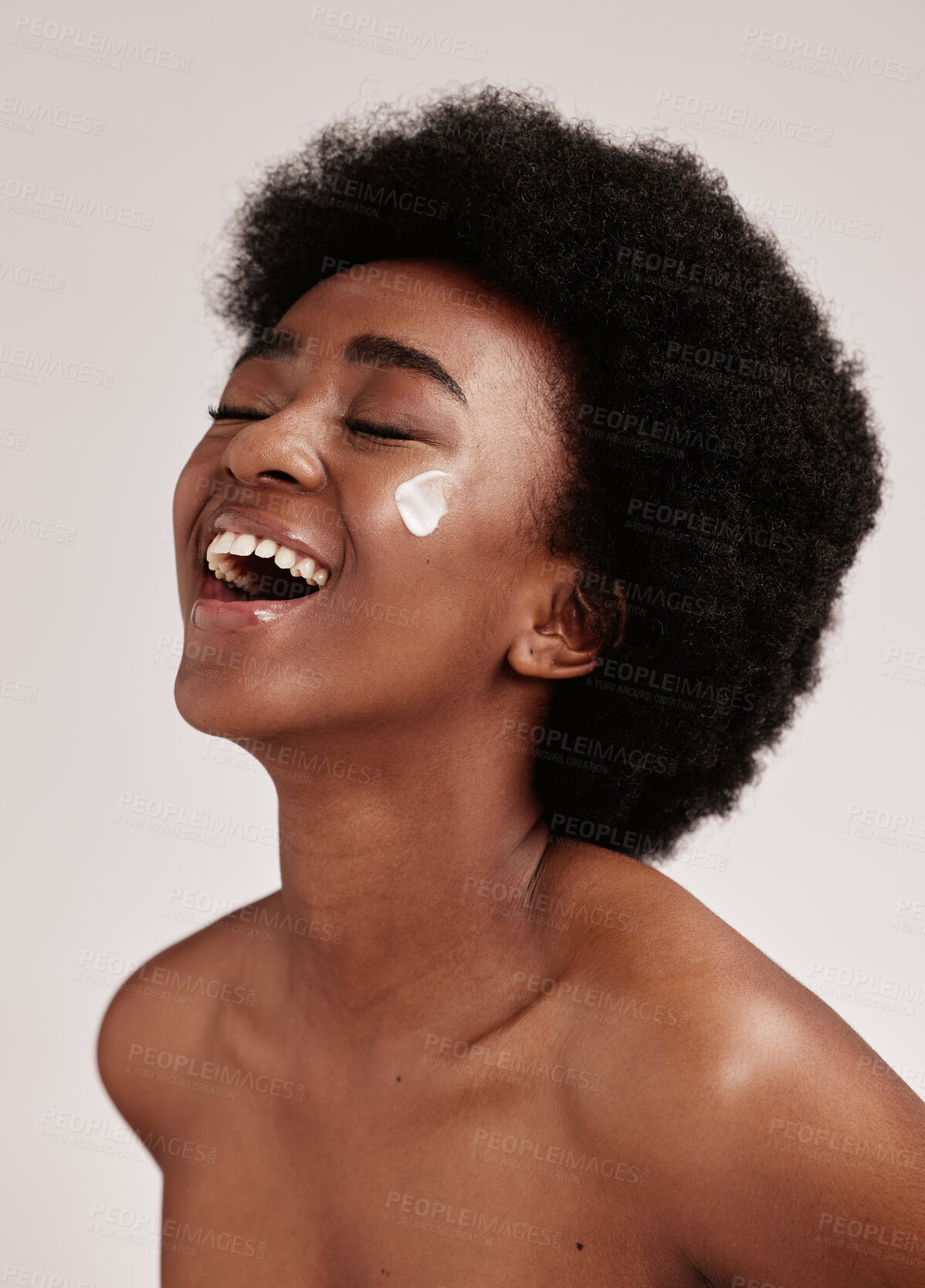 Buy stock photo Beauty, smile and black woman with cream on face, afro and excited advertising for luxury skin product promotion. Dermatology, cosmetics and salon facial for happy model isolated on studio background