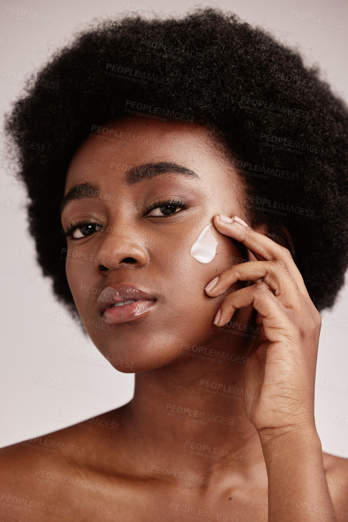 Buy stock photo Skincare, face and portrait of black woman with lotion, afro and advertising luxury skin care with collagen product promotion. Dermatology, cosmetic and facial for model isolated on studio background