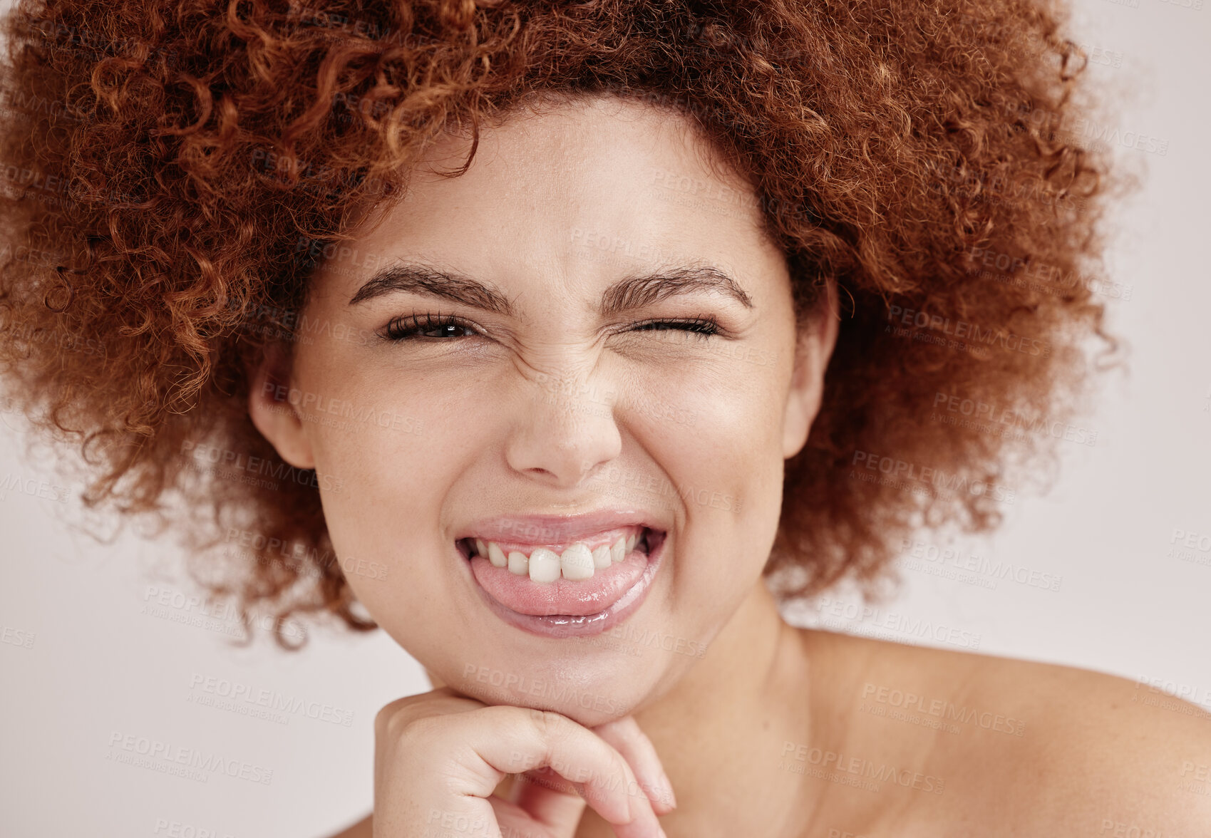 Buy stock photo Black woman face, wink and beauty with smile, funny facial expression with skincare and natural hair on studio background. Healthy skin, cosmetics and teeth, dermatology and wellness in portrait