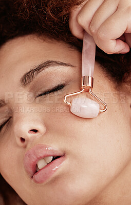Buy stock photo Skin care, face roller and woman doing massage in studio with dermatology and cosmetic tools. Aesthetic model with hands for spa facial product for health, wellness and natural  skin youth glow 